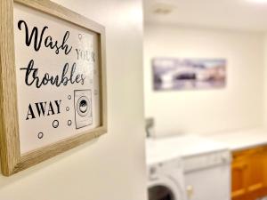 a bathroom with a sign that readswalk troubles away at Paris Charm Modern 4B3B, Kitchen, Parking,5G in Richmond Hill +44 photos