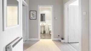 a white bathroom with a toilet and a sink at Govandale Seaviews in Kingarth
