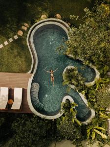 a woman is standing in a swimming pool at The Benison in Ahangama