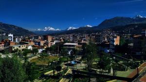 a city with snow capped mountains in the background at Mirador Backpackers B&B in Huaraz