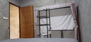 a bedroom with a bed and a window at Fahad Calm House in Ko Lanta