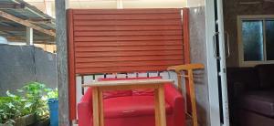 a red chair sitting on a porch next to a door at Fahad Calm House in Ko Lanta +2 photos