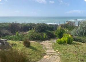 a path through a field with the ocean in the background at Bodega Bay Magical Ocean Front w/Amazing View! in Bodega Bay