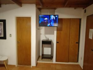a living room with a flat screen tv on the wall at Hotel Cristal in Viedma