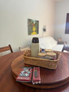 a basket on top of a wooden table with food at Temporada AK Freitas in Parnaíba
