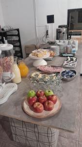 a counter with plates of apples on a table at Hotel Cristal in Viedma