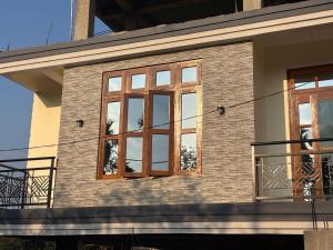 a house with windows on the side of it at Janaa Residence in Dithur