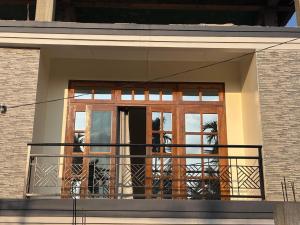 a balcony with a wooden door and a window at Janaa Residence in Dithur +7 photos