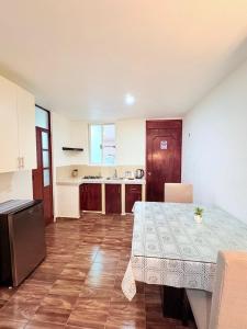 a kitchen with a table and a table and a table and a kitchen at Hospedaje La Gardenia in Zacatlán