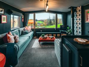 a living room with a couch and a table at The Game Keeper - Uk50611 in Sabden