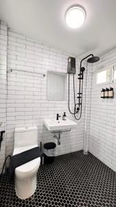 a bathroom with a white toilet and a sink at Little Escape in Bangkok