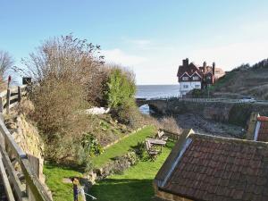 a house on a hill next to the ocean at Sunnyside in Sandsend