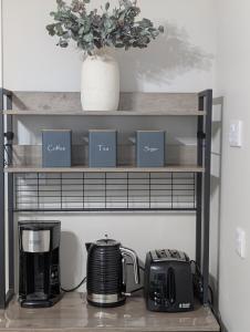 a shelf with a coffee maker and a toaster at Self-catering in Portree in Portree