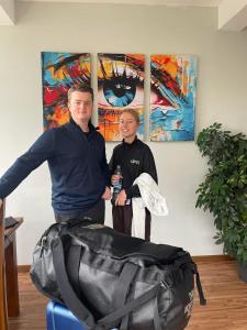 a man and woman standing in front of a bag at Ambula Resort in Nuwara Eliya