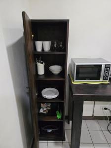 a microwave oven sitting on a counter next to a table at Hotel Don Fito in Golfito