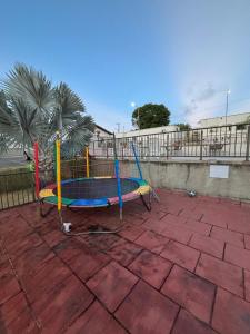 a playground with a trampoline on a brick ground at Torres dos Holandeses Vista Mar in São Luís
