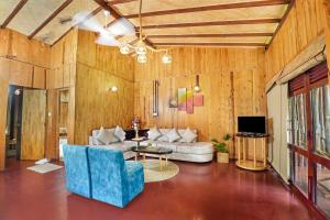 a living room with a couch and a tv at Lake Resort Bolgoda in Wadduwa