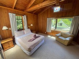 a bedroom with a bed with a pink towel on it at Abel Tasman guest house in Marahau