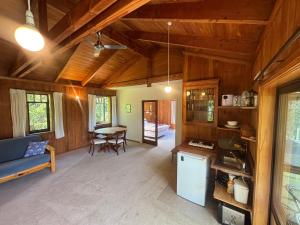 a living room with a blue couch and a table at Abel Tasman guest house in Marahau