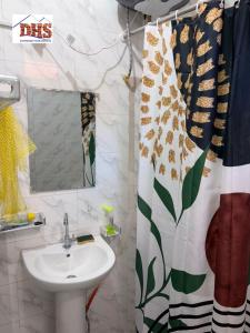 a bathroom with a sink and a shower curtain at DHS Home in Pikine