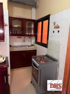 a kitchen with a stove and a sink at DHS Home in Pikine +13 photos