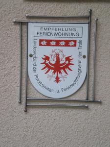 a sign hanging on the side of a building at Aparthaus Aktiv in Neustift im Stubaital