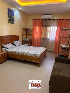 a bedroom with a bed and a couch at DHS Home in Pikine
