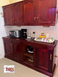 a kitchen counter with a microwave on top of it at DHS Home in Pikine