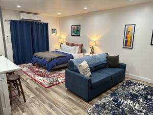 a living room with a bed and a couch at Scenic Farmhouse in Riverton