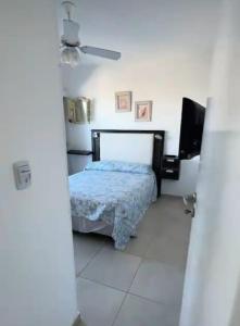 a bedroom with a bed and a flat screen tv at CoSTA Y MAR II in Villa Gesell