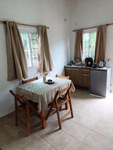 a kitchen with a table and chairs in a room at Mi sueño apart en Mercedes Corrientes!!! in Mercedes