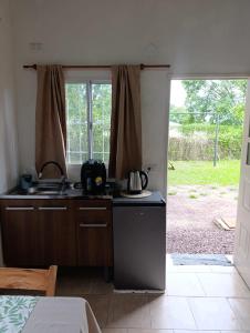 a kitchen with a sink and a stove at Mi sueño apart en Mercedes Corrientes!!! in Mercedes