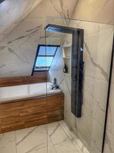 a glass shower in a bathroom with a window at La Pergola-4 in Quebec City +10 photos
