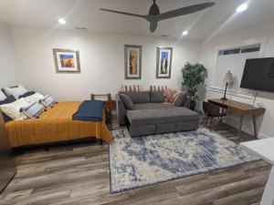 a living room with a bed and a couch at Scenic Farmhouse in Riverton