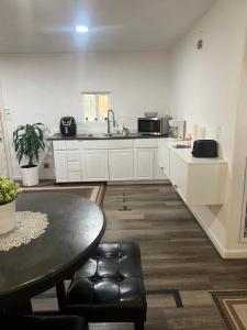 a kitchen with a table and a sink and a counter at Near Red Mountain park in Mesa