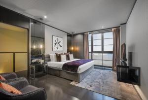 a bedroom with a king sized bed and a tv at Hinode Hills Niseko Village in Niseko +121 photos