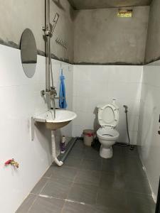 a bathroom with a toilet and a sink at Friendly Homestay & Authentic Trekking Tours in Sapa