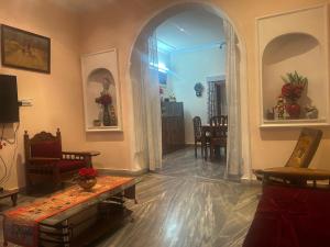a living room with an archway and a living room at Smriti- loving memories in Jaipur +7 photos