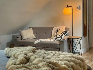 a living room with a couch and a blanket at La Pergola-4 in Quebec City