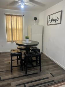 a dining room with a table and chairs and a refrigerator at Near Red Mountain park in Mesa +21 photos