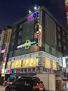 a building with neon signs on the side of it at 평촌코아 in Mabun-ni