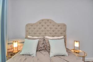 a bedroom with a large bed with two lamps at 2 BR Cottage Midtown Downtown EADO in Houston