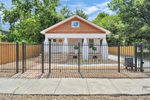 a fence in front of a small house at 2 BR Cottage Midtown Downtown EADO in Houston