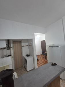 a room with a kitchen with a refrigerator and a stove at Studio em Piedade in Rio de Janeiro