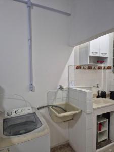 a small kitchen with a sink and a toilet at Studio em Piedade in Rio de Janeiro