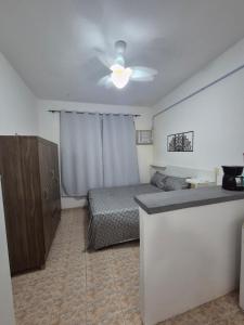 a bedroom with a bed and a ceiling fan at Studio em Piedade in Rio de Janeiro