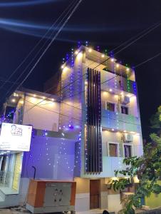 a building with christmas lights on the side of it at Hotel 7R RESIDENCY in Jhānsi