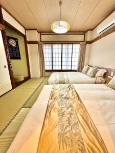 a room with two beds and a chandelier at Private Room near Iriya in Tokyo