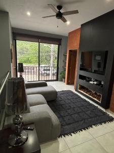 a living room with a couch and a fireplace at C apartment in Ajijic
