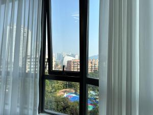 a view of a city from a window at JOYINN HOTEL Guangzhou Zoo Shaheding Metro Branch & Guangzhou Beijing Road Pedestrian Street & Canton Fair Nearby 桔迎酒店-广州动物园沙河顶地铁站店 in Guangzhou